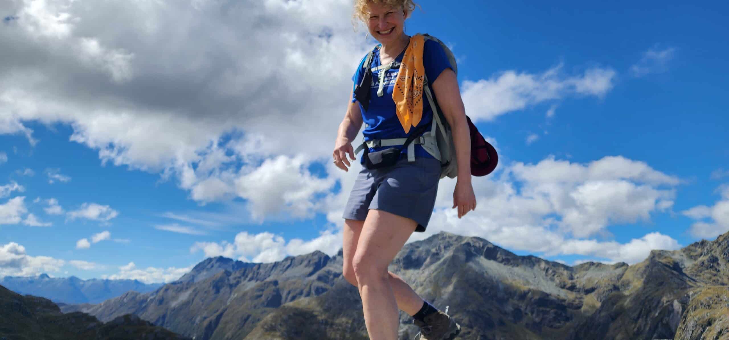 smiling woman hiking Routeburn Track